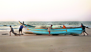 A rare sight as fishermen work their nets on their lone boat on the Benaulim beach.