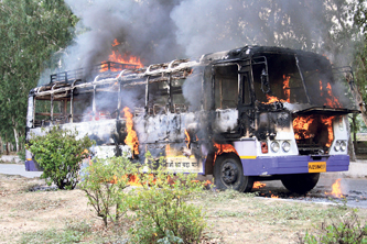 A Rajasthan Roadways torched by protesting farmers. 