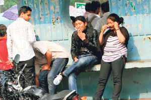 Despite a ban on smoking in public places, a man smokes at a bus stop near the school education board in Dharamsala on Saturday.