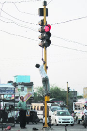 A man works on traffic lights in Jammu. 