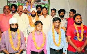 Shamsher Singh Manhas, state president of the BJP, along with the new party members at the party headquarters in Jammu. 
