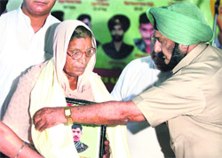 Lt-Col Manmohan Singh (retd) honours a relative of a martyr in Jalandhar on Sunday
