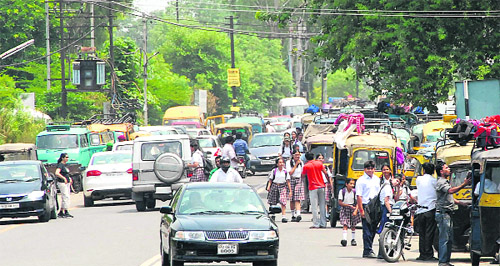 Auto-rickshaw drivers, rickshaw-pullers and parents of students create traffic chaos outside educational institutions in Jalandhar Cantonment.
