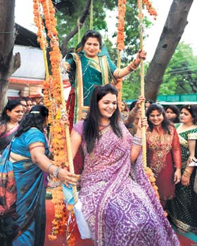 Women celebrating on the eve of Sawan Mahotsav in Bhopal on Sunday