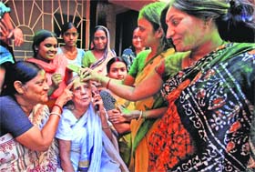 Family elated: Pranab Mukherjees elder sister Annapurna Devi celebrates with family members at her residence on Sunday