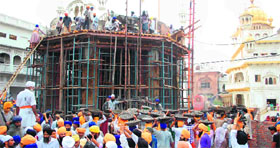 Sikhs perform 'kar sewa' of the Operation Bluestar Memorial.