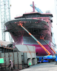 Workers build a ship at the ABG Shipyard, Indias largest private sector shipyard, at Magdalla port near Surat. The second of three pollution control vessels being built here was inducted into the Coast Guard last week.  AFP