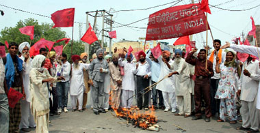 CPI workers protesting against the hike in power tarrif as well as the additional tax levied on sugar, near Gol Diggi in Bathinda on Monday. 