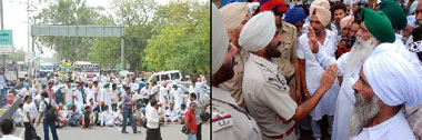 Protesting against the death of a woman after she delivered twins at a private hospital in the city, members of Bhartiya Kisan Union (Ugrahan) block the Bathinda-Mansa road; A police personnel (right) tries to pacify one of the protesters. 