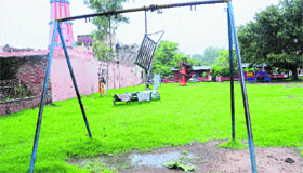 A broken swing at a park in Sector 32 and benches used for drying clothes.