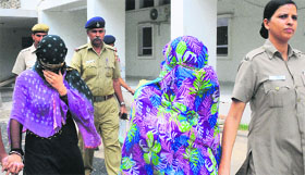 Chandigarh Police officials with the two accused, Khushi and Suneeta, at the district court, Sector 17, Chandigarh, on Monday.