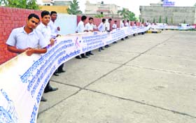Youths hold a 124-metre banner during an awareness rally in Kurukshetra on Monday, signifying that the countrys population has reached 124 crore
