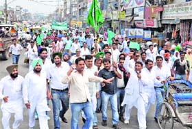 INLD workers hold a protest rally in Karnal on Monday
