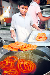 A boy prepares the famous jalebis of Gohana in Sonepat district to serve customers.
