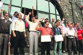 Employees of the Municipal Corporation raise slogans in support of their demands in Shimla on Monday.