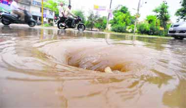 Rainwater forms a whirlpool as it seeps into the sewerage near the Sarabha Nagar police station in Ludhiana on Monday. 