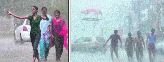 Girls enjoying monsoon showers in Ludhiana on Monday. Tribune photo: Himanshu Mahajan; (Right) Youths heave a sigh of relief at Ghumar Mandi Chowk in Ludhiana on Monday.