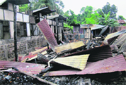 Remains of a house that was burnt during clashes in Kokrajhar district of Assam on Monday.  PTI