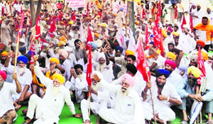 Farmers stage a protest in support of their demands in Ajnala on Monday.