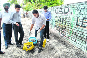Employees of the Punjab Pollution Control Board remove medical waste from the Badungar Chowk in Patiala on Monday.