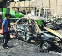 A man at the scene of a car bomb blast in the Shiite bastion of Sadr City, eastern Baghdad, on Monday. 