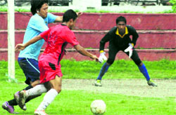 Players in action during a match in the 3rd ONGC-BS Negi Memorial Football Tournament under way at Ambedkar Stadium in Dehradun on Tuesday.