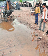 Unhygienic conditions prevail around 'jhuggis' near the garbage dump.