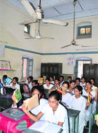 School students in Patiala use textbooks as hand fans to beat the heat