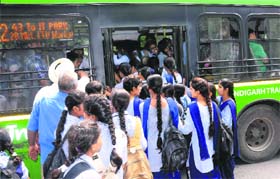 Students try to board an overcrowded CTU bus in Chandigarh