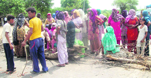 Protesters block the Jind-Rohtak highway at Kila Zafargarh village on Wednesday.