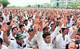 Employees of Honda Motorcycle and Scooter India observe the seventh anniversary of the uprising in Gurgaon on Wednesday. 