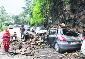 A vehicle buried in a landslide after heavy rainfall in Shimla on Wednesday