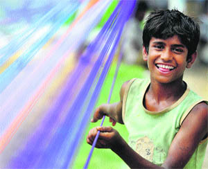 A kitemaker prepares strings in Jammu. 