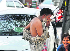 A man smokes in a public place at the Gole Market area in Jammu on Wednesday. 