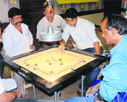 Carrom tournament in progress at Panchkula on Wednesday. (Inset) Winners recieves trophy at the closing ceramony. 