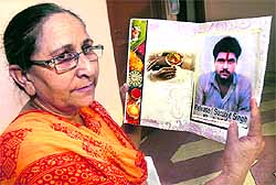 Dalbir Kaur, sister of Sarabjit Singh who is lodged in a Pakistan jail, shows the card she is sending to her brother on the occasion