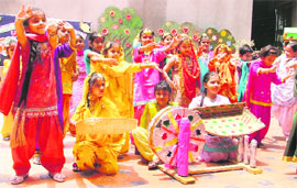 Students of Green Land Senior Secondary Public School celebrate Teej in Ludhiana on Wednesday. 
