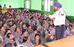 Traffic police officer addresses students at Sargodha Public School in Ludhiana on Wednesday. 