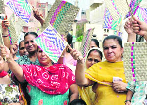 Women hold a protest against power cuts in Patiala on Wednesday. 