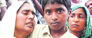 A wailing Shinder Kaur(left) at the cremation of her son Neetu at Akalia village in Mansa district on Tuesday.
