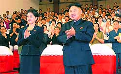 The mystery woman (above) often seen with North Korean leader Kim Jong-un was on Wednesday identified by state television as his wife, comrade Ri Sol-Ju
