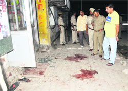 Police officials inspect the crime site at Sector 22-A in Chandigarh on Thursday. Tribune Photos: Pradeep Tewari