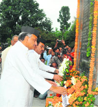 Chief Minister Vijay Bahuguna with Uttarakhand Soldiers' Welfare Minister Harak Singh Rawat pay floral tributes at the Kargil war memorial in Dehradun on Thursday.