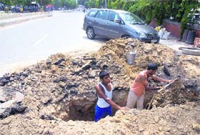 The drainage system outside the DC office being re-installed to deal with the problem of accumulation of rainwater on the road in Jalandhar on Thursday