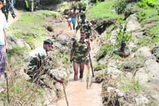 BSF personnel carry out a rescue operation in the Seri area of Rajouri district on Thursday. 