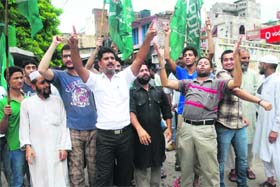 Residents of Talab Khatikaan protest against the power department over unscheduled power cuts in Jammu on Thursday