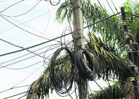 A mesh of tangled wires on an electricity pole in Jammu