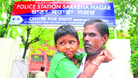 Arvind Kumar, a rickshaw-puller, with the boy who was found abandoned near a temple at Sunet village.