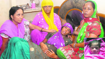 Anita, the mother of the child (inset), with her relatives. 