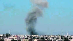 Smoke billows from buildings in Talbisseh, north of Homs. 